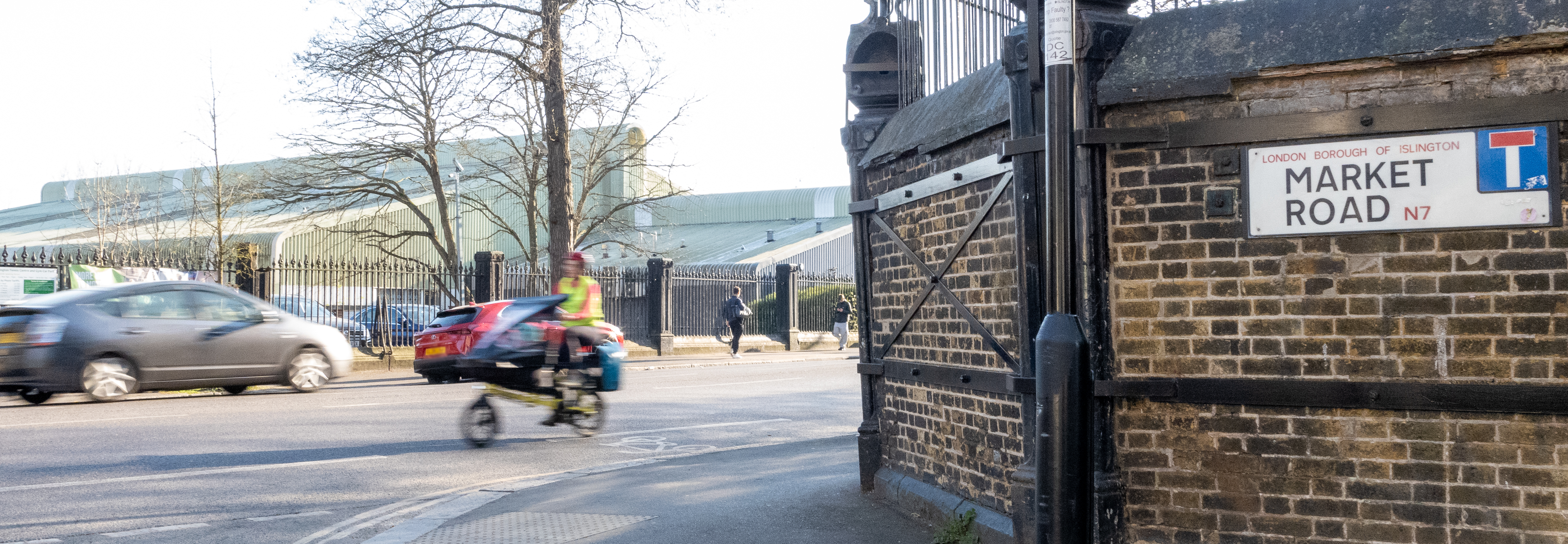 Photography Market Road showing the market Road sign with car and cycle traffic.  