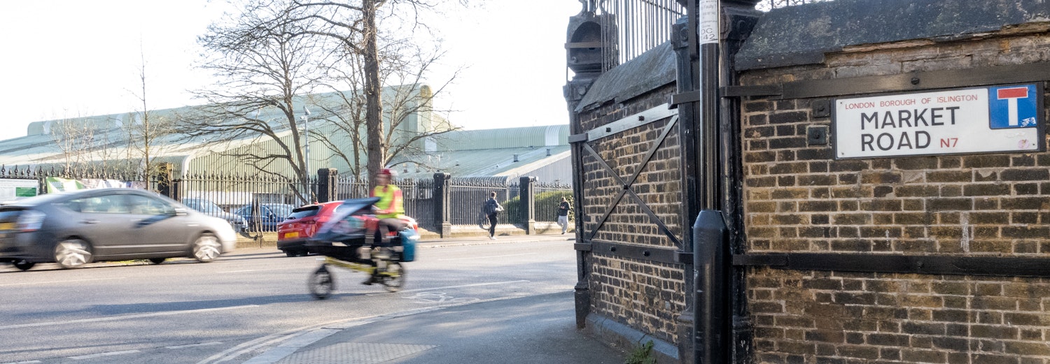 Photography Market Road showing the market Road sign with car and cycle traffic.