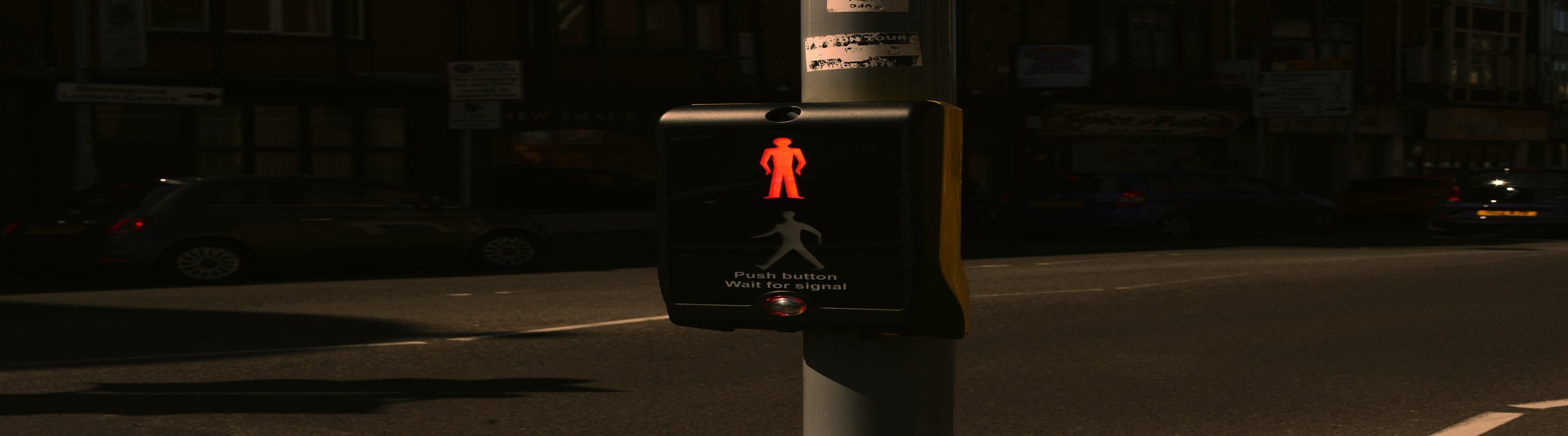 Photo of Puffin crossing button control at night.
