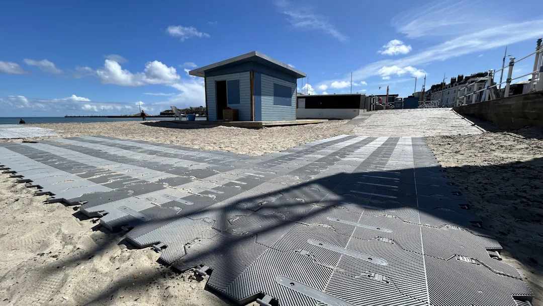 Image of Weymouth Beach showing deckchairs on the promenade.