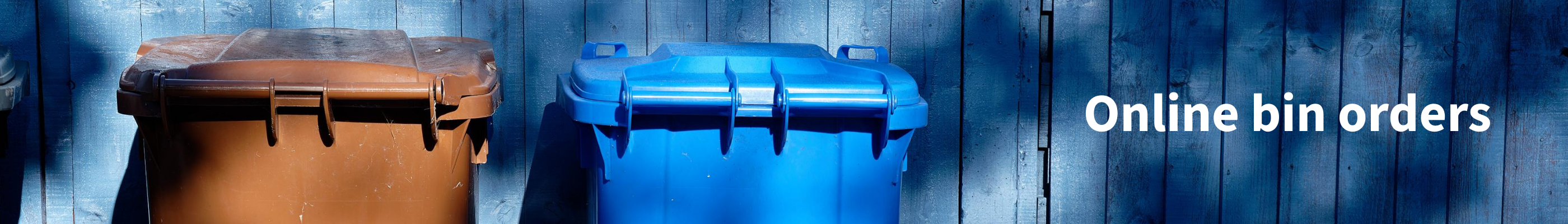 Image of blue wooden background with a brown bin and blue bin sitting at the front. Text reads online bin orders.