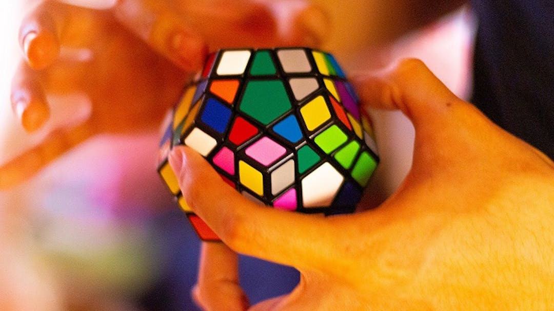 Man holding Rubik's cube in hand