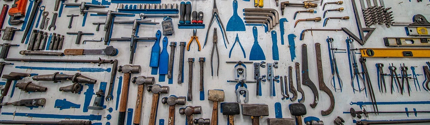 A range of tools neatly arranged on a surface