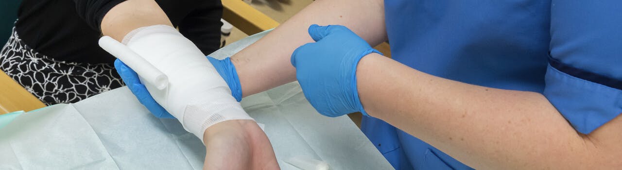 Patient getting treated by nurse for a minor injury