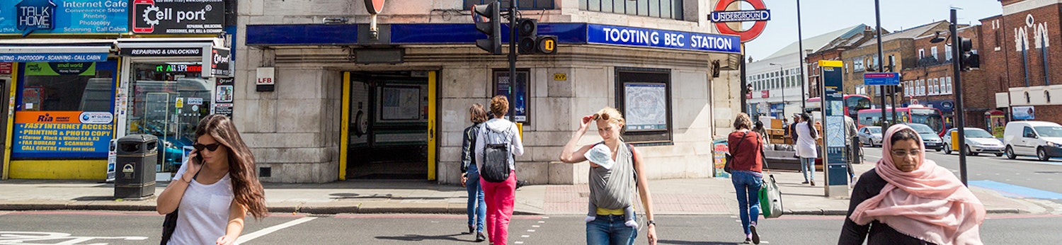 People crossing street at Tooting Bec station