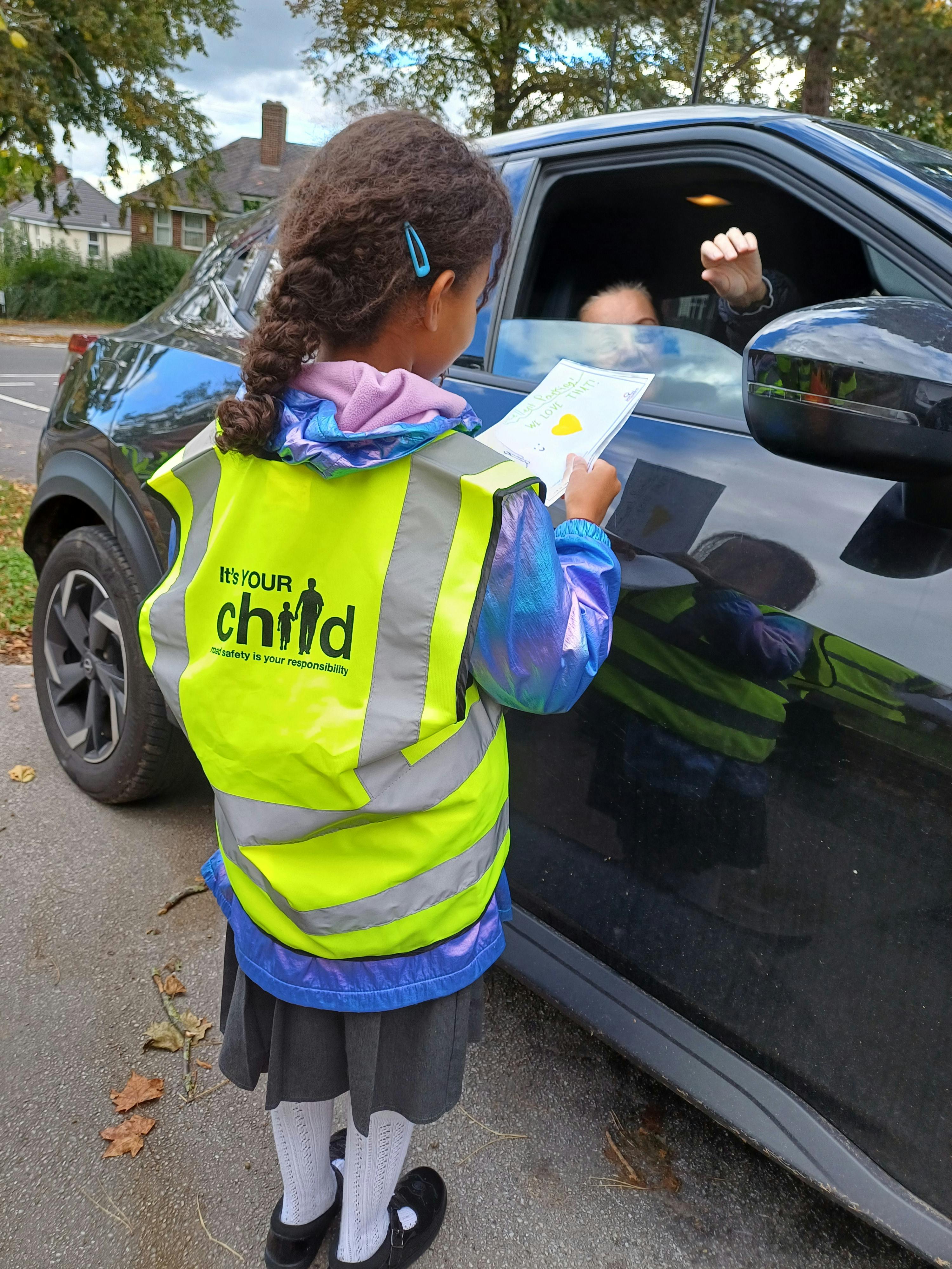 Child handing over a Good Parking Ticket