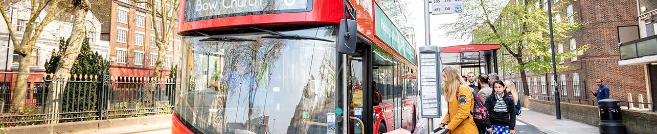 Image of passengers entering a double decker bus at a bus top 