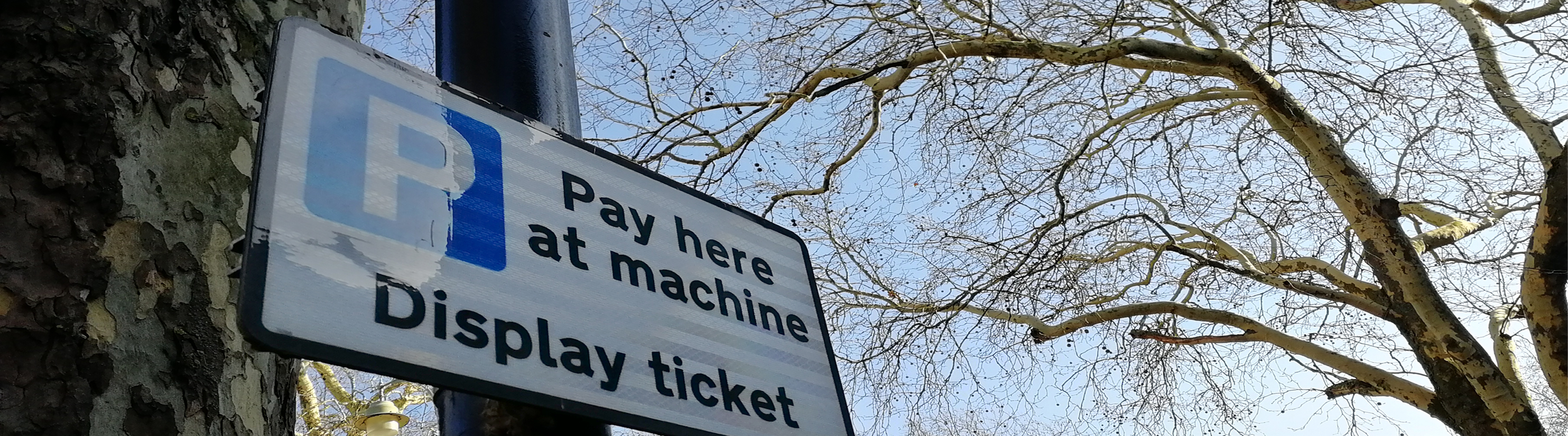 Carpark sign: Pay here  at machine. Display Ticket.