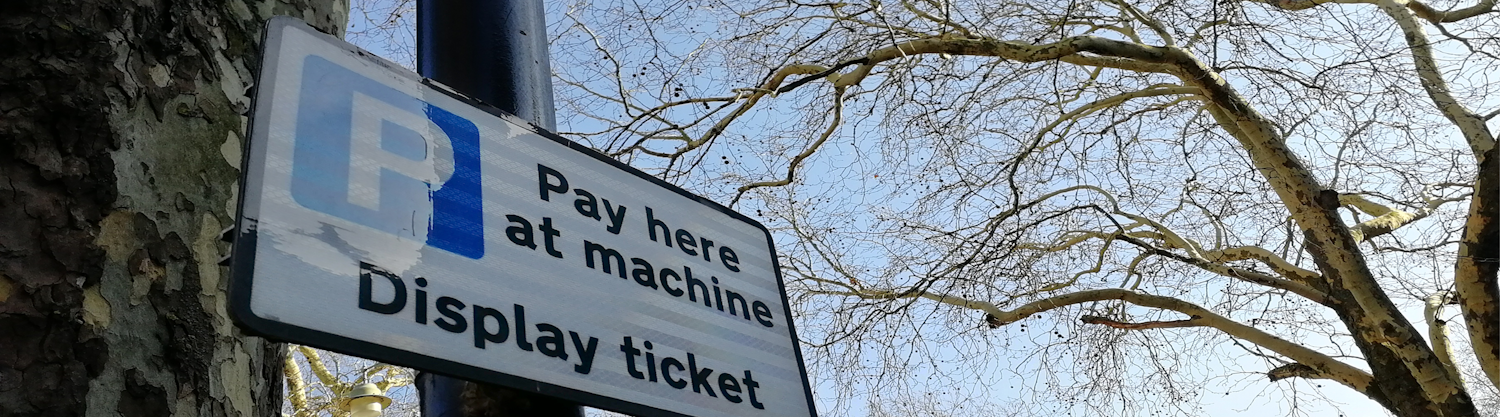 Carpark sign: Pay here  at machine. Display Ticket.