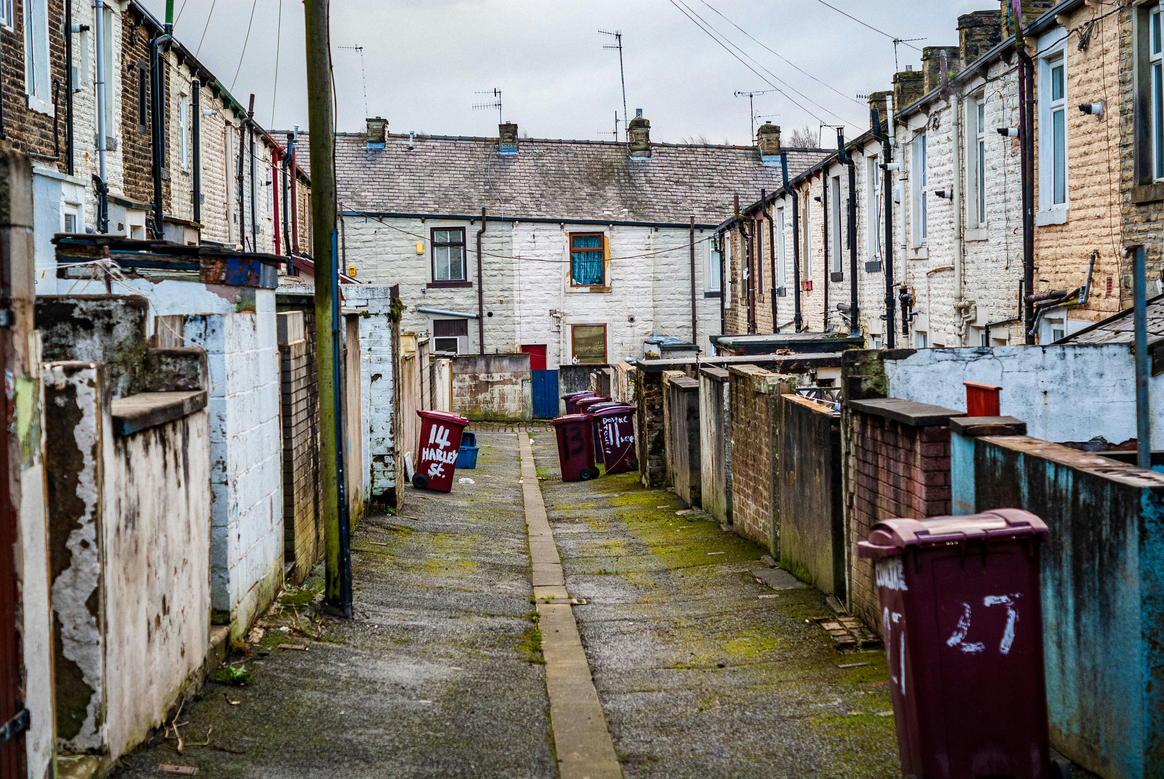 A back alley with bins awaiting collection