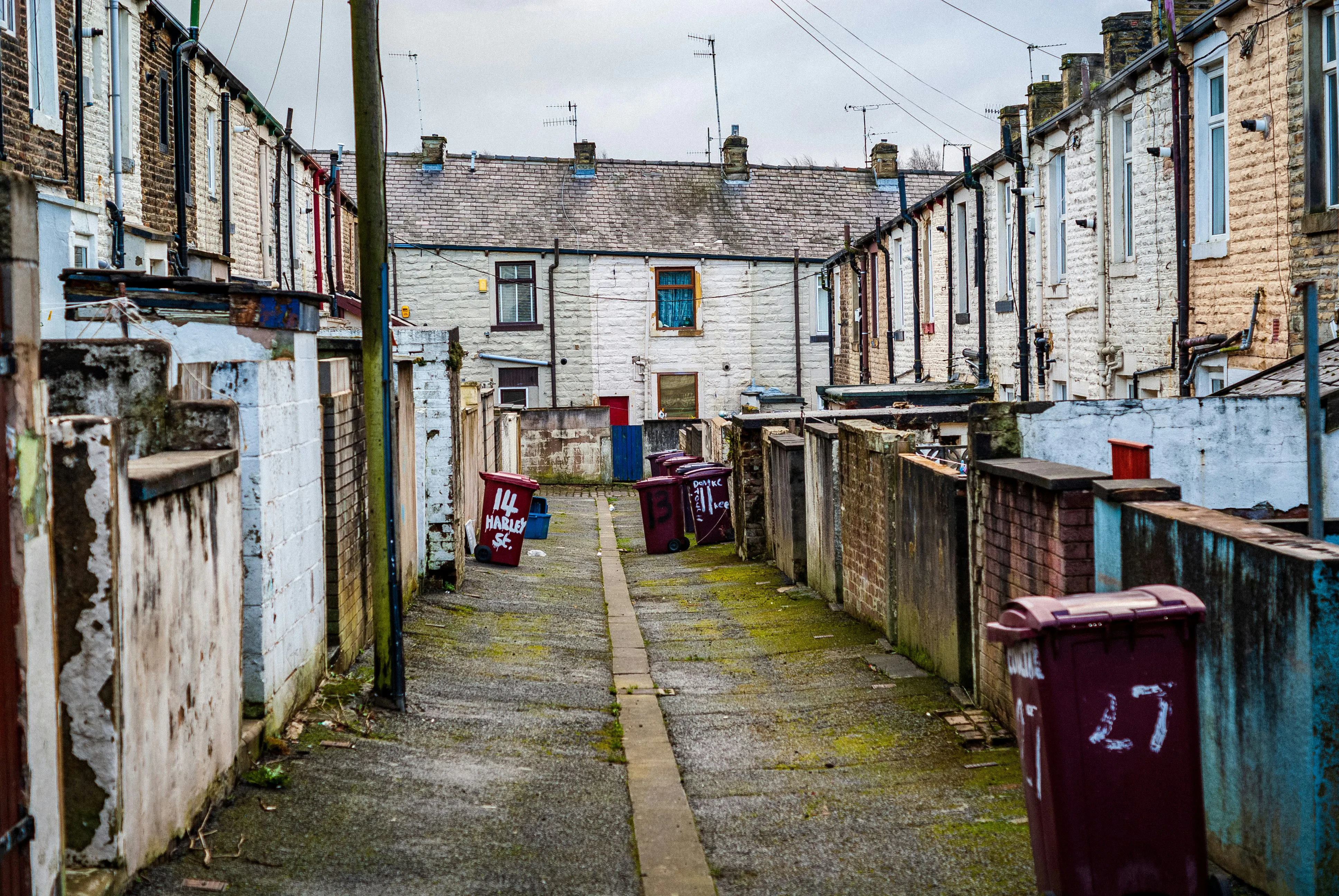 A back alley with bins awaiting collection