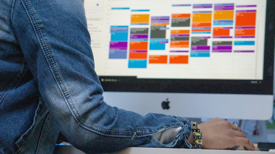 Person sitting in front of a laptop opened on a calendar planning tool page