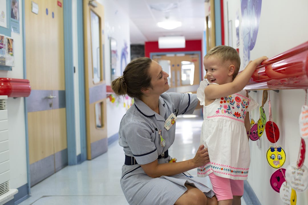 Nurse and young patient in hospital corridor