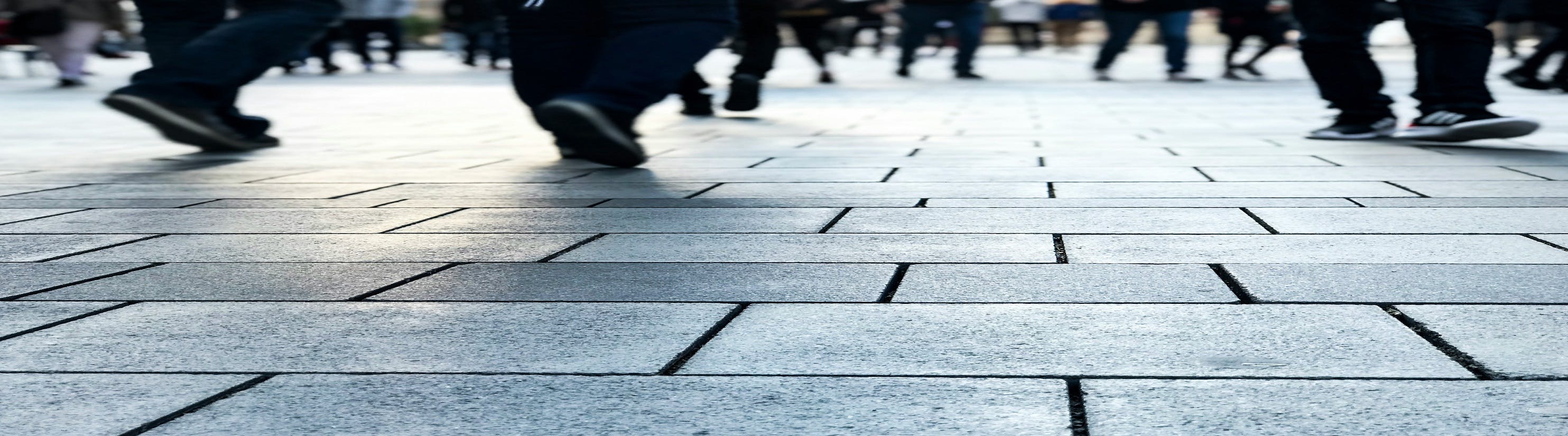 Photo of people walking on paved surface.