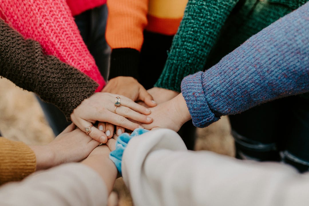 Hands all together in the centre of the page