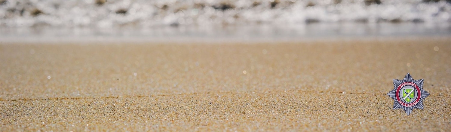 An image of the beach with sand and sea in the background