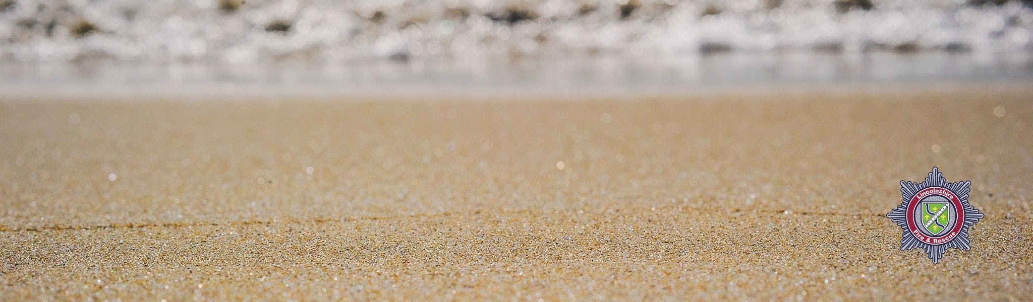 An image of the beach with sand and sea in the background