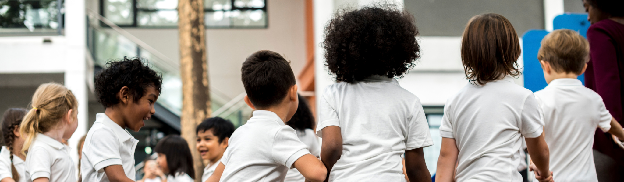 image of children walking together in a circle outside 