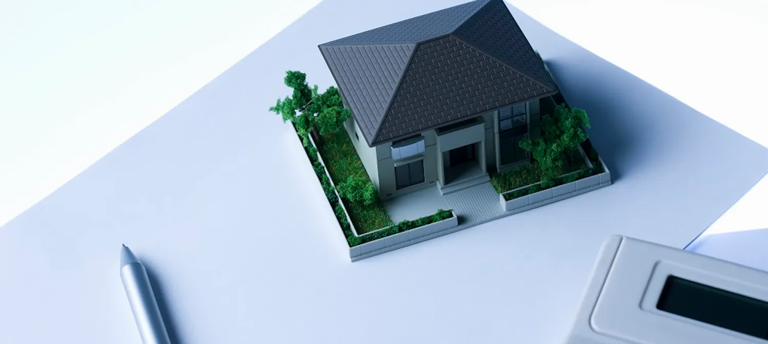 Image of house, pen and calculator