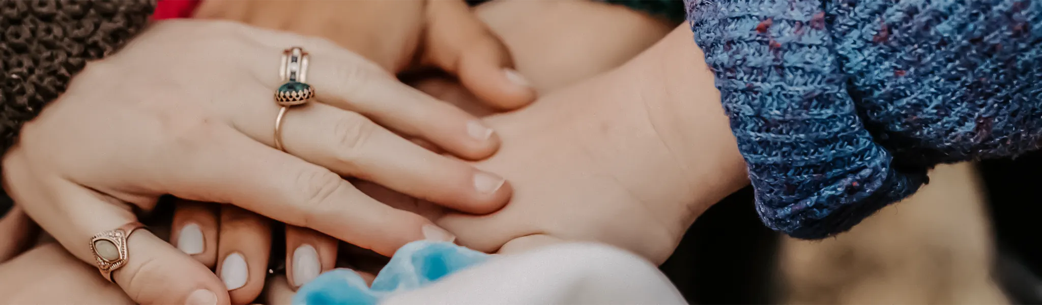 Hands laid over the top of each other