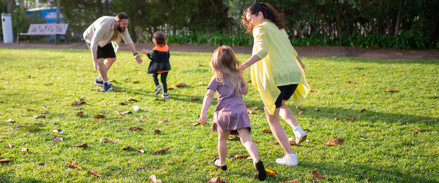 Photo of a family playing outside.