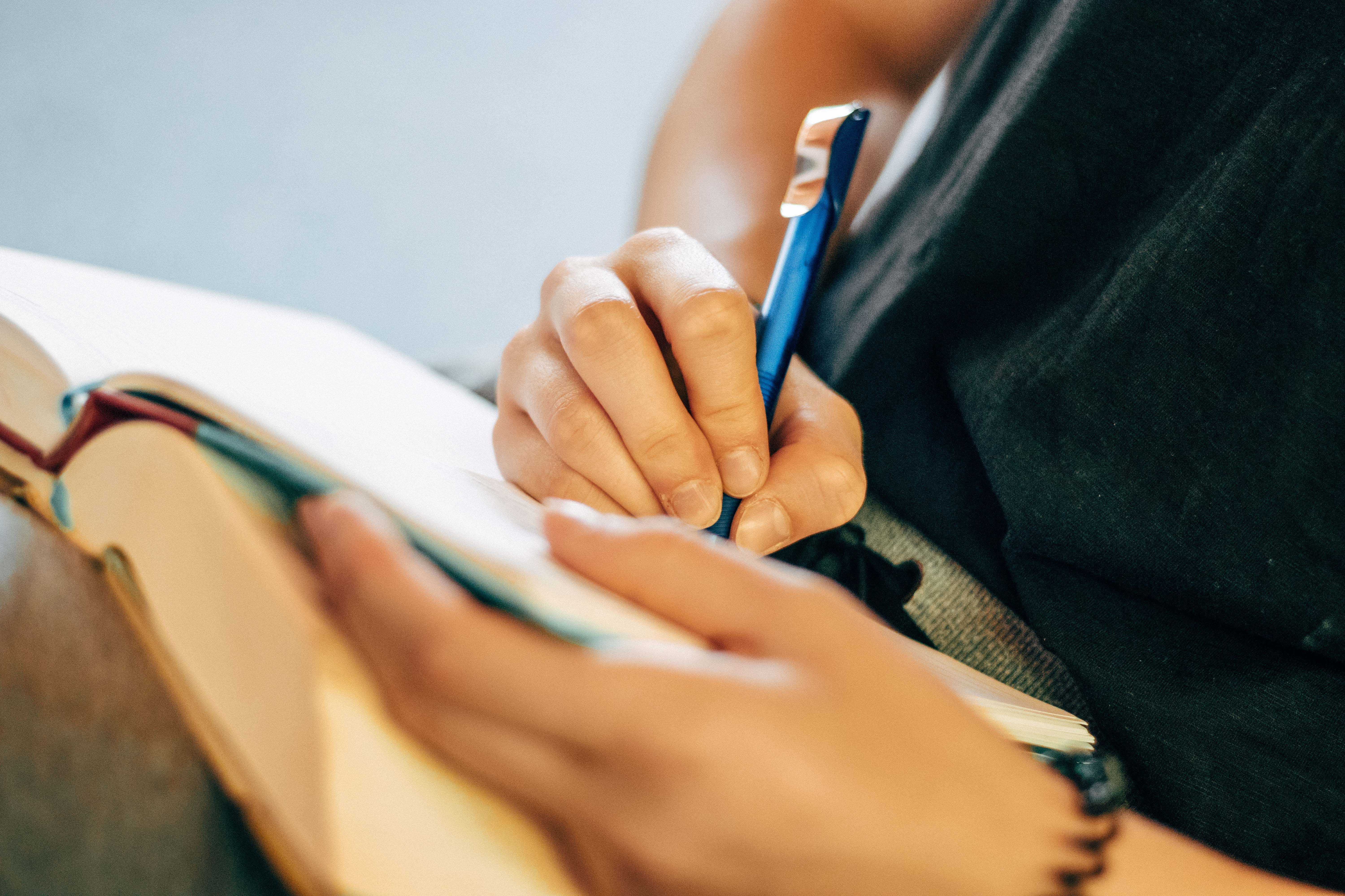 A woman writing in a note book