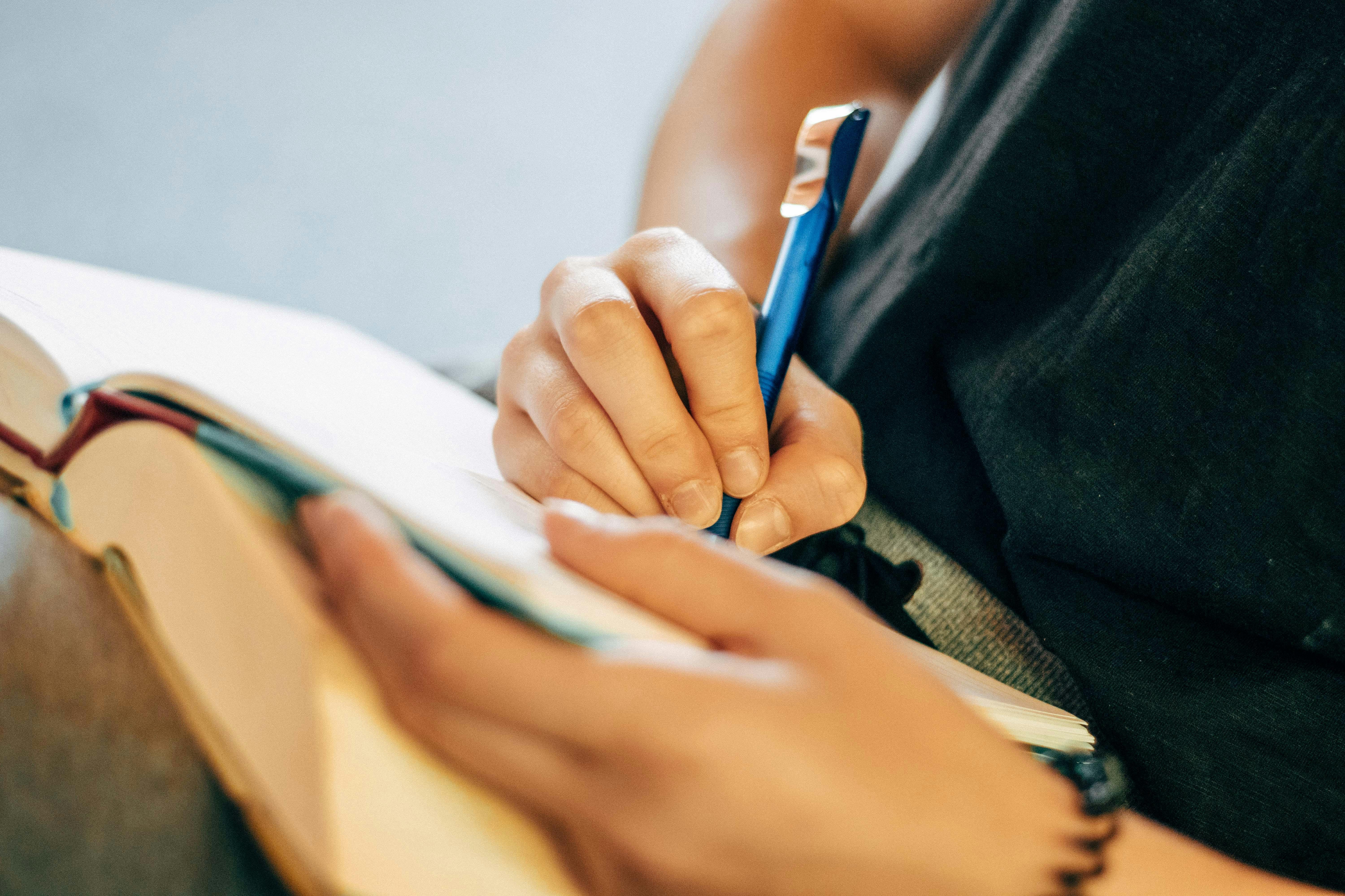 A woman writing in a note book