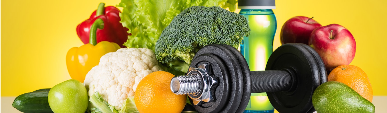 An image of fruit, veg and dumbbells