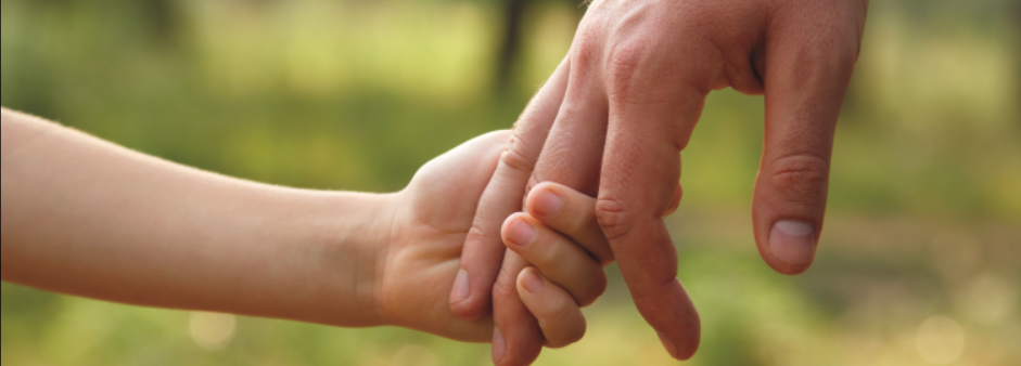 Adult and child holding hands
