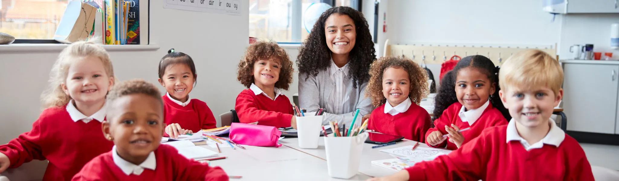 An image of a teacher and a group of children in a classroom