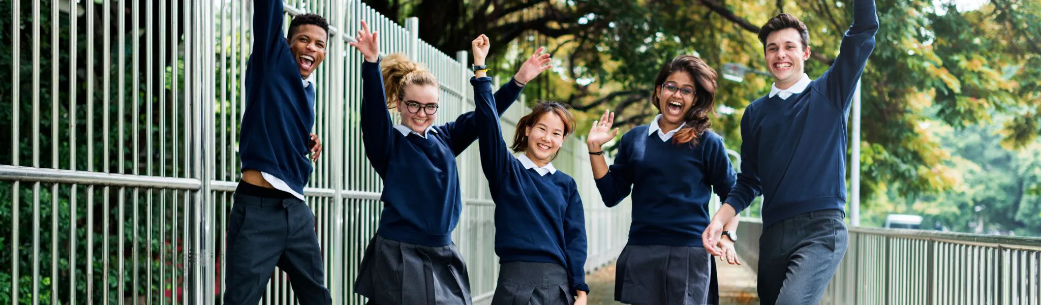 Group of students jumping and smiling