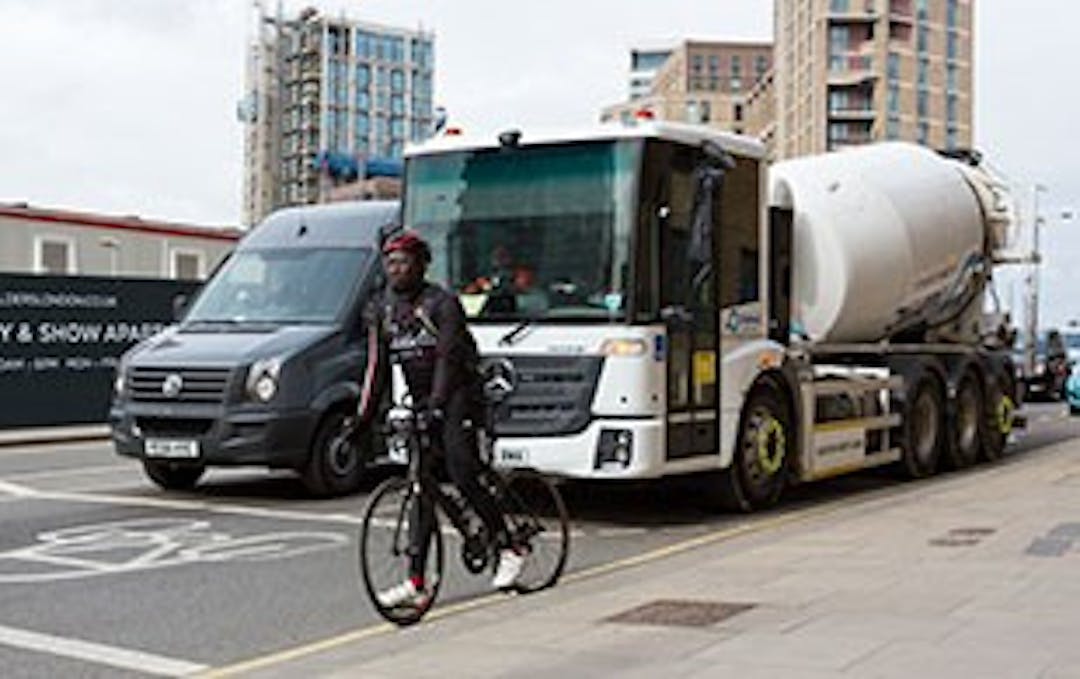 HGV with cyclist riding slightly in front