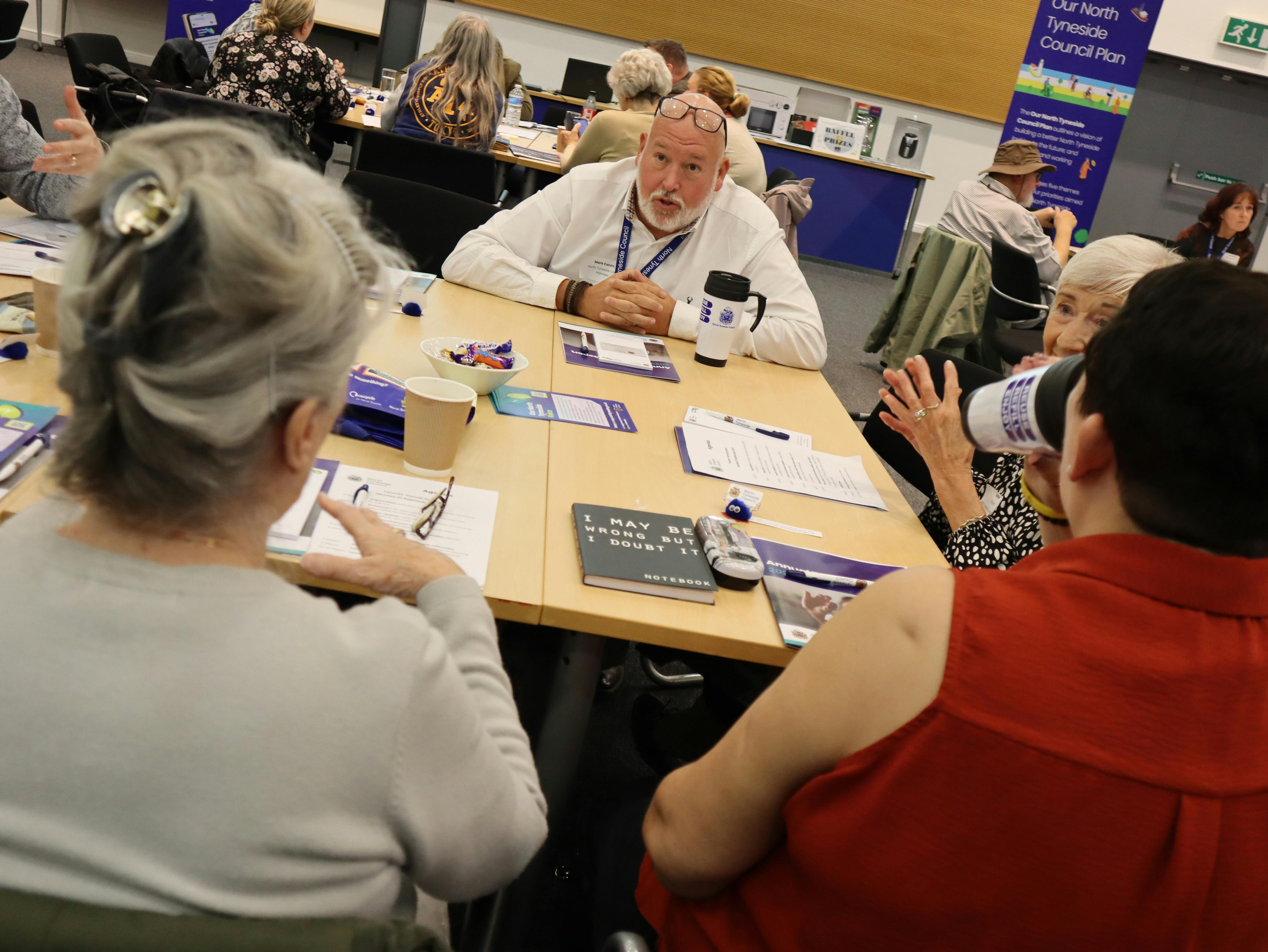 Tenants and housing service staff in discussion at the annual tenants' event