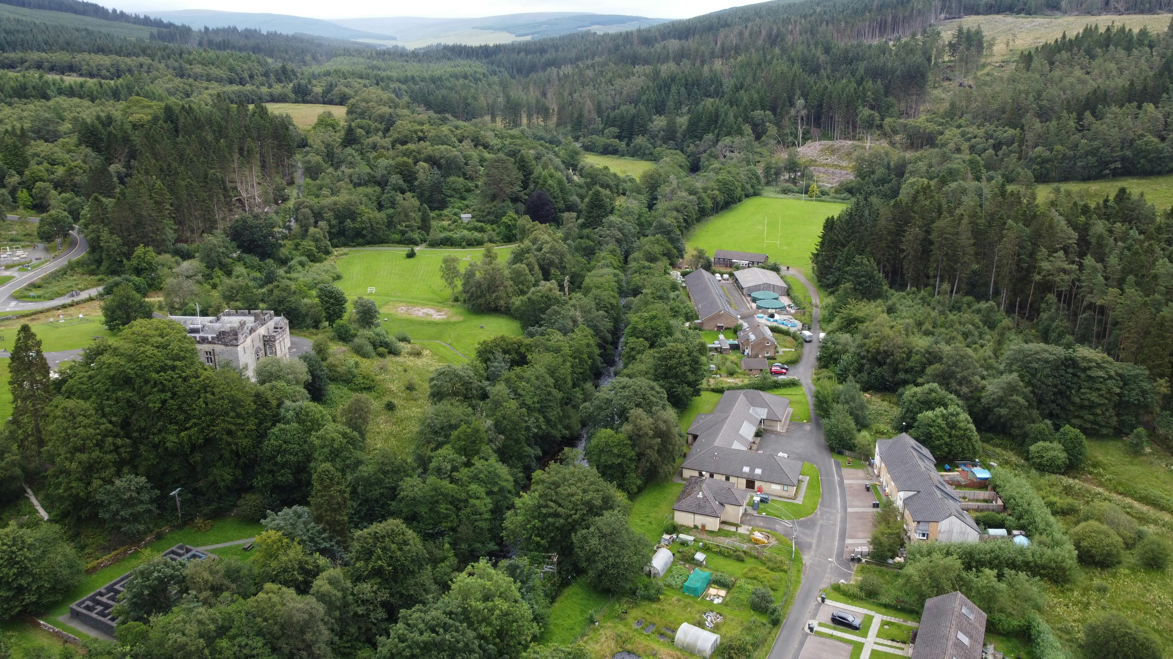Drone Photograph showing the dense woodland and steep valley upstream of Butteryhaugh Village