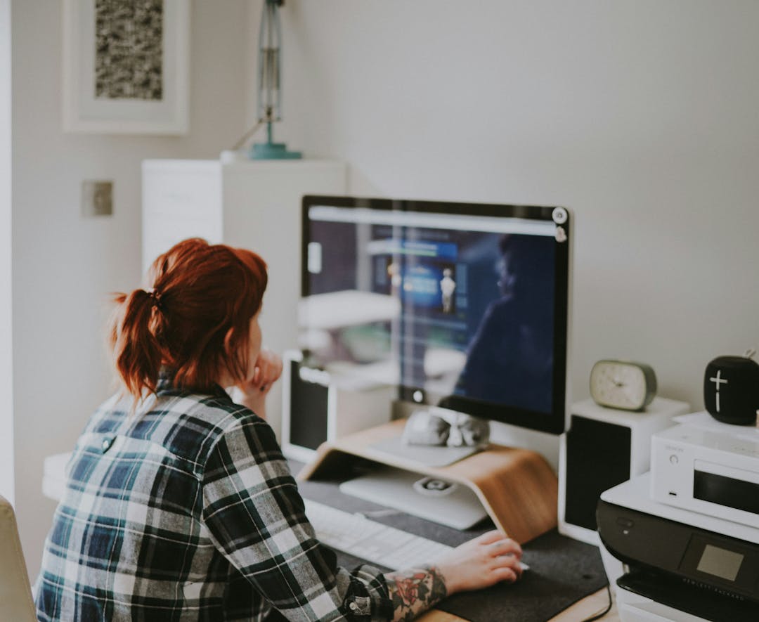 Female sitting in front of a PC for an online learning session