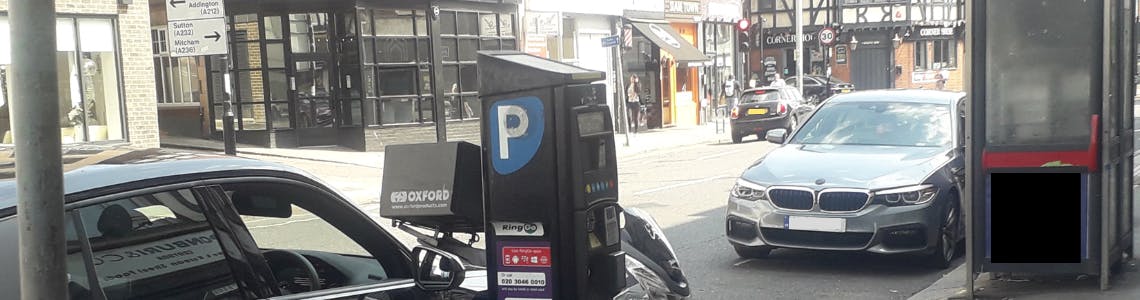 Photo of cars parked on South End, Croydon with parking meter, buildings and telephone box