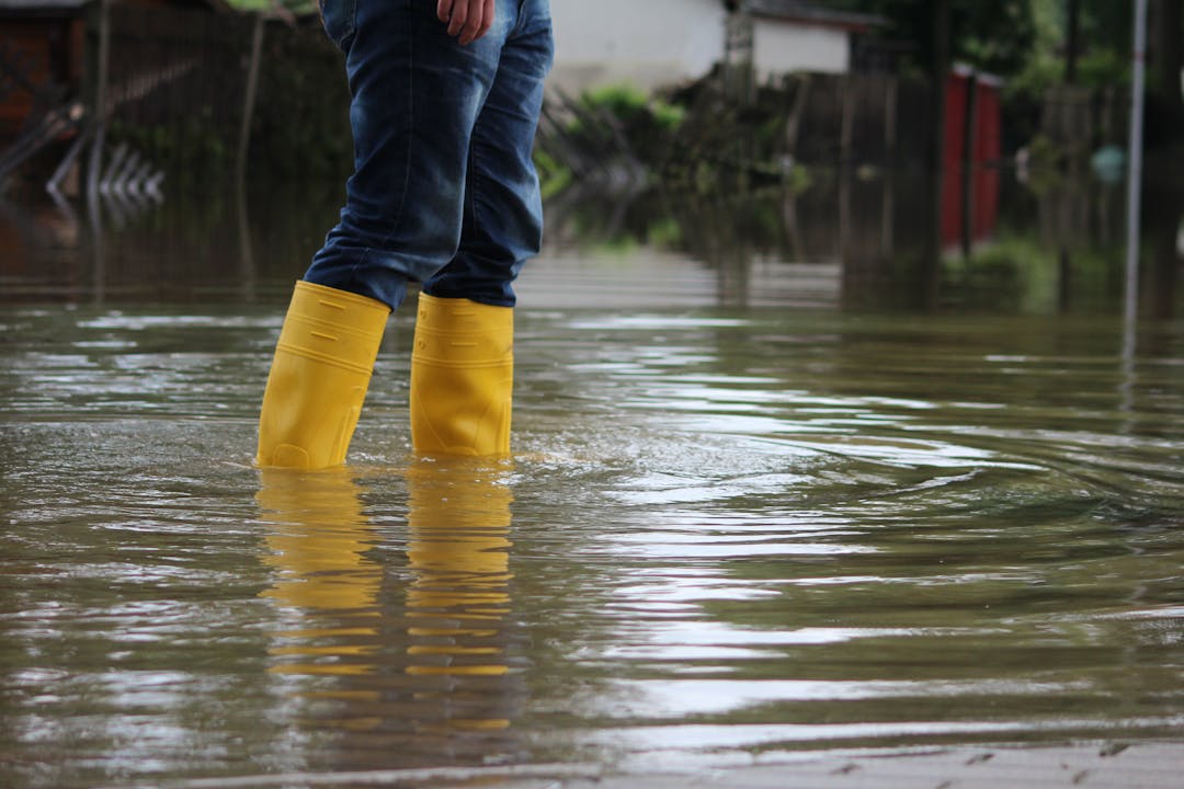 Person in a yellow wellington boots standing in water