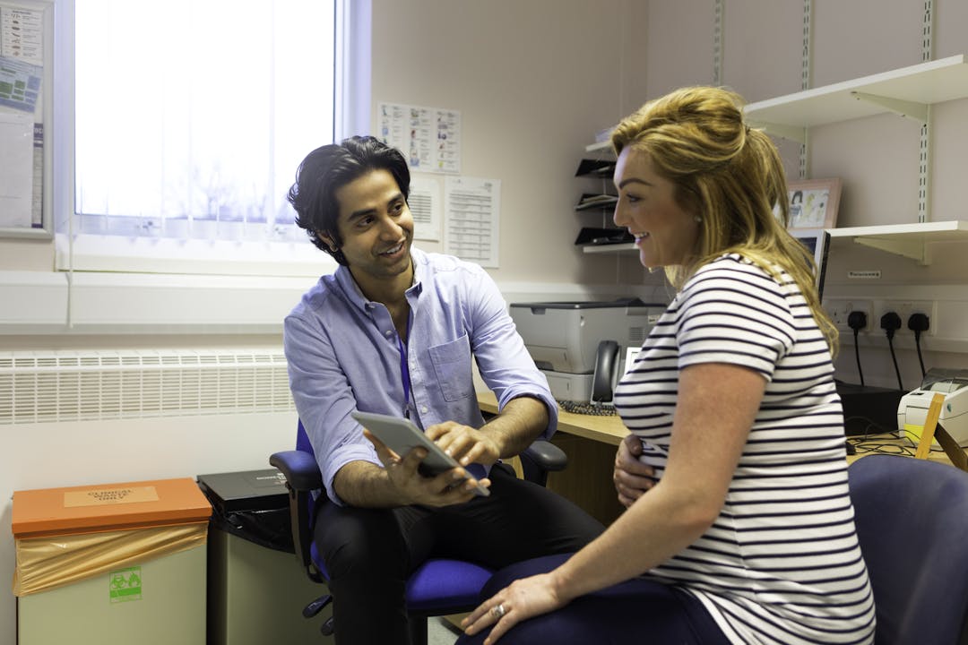 Pregnant woman having a checkup with male doctor