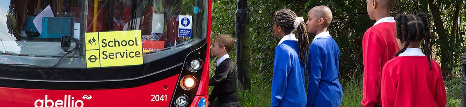 Young people boarding a London bus to travel to school