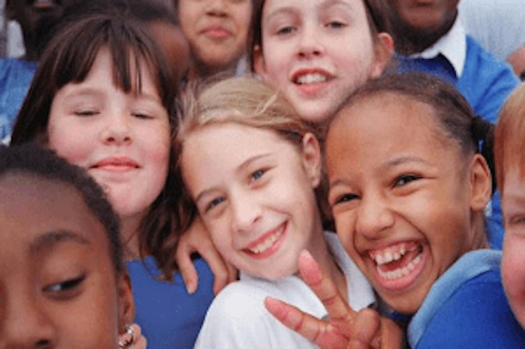 A group of smiling children in school uniform.