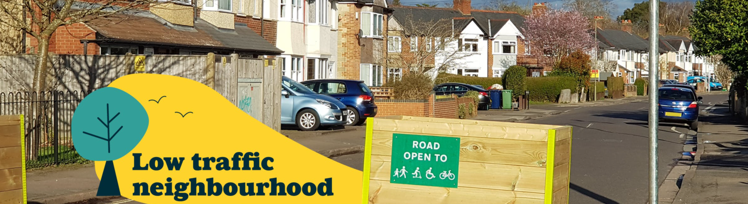 Photo of planter style road barrier and Low Traffic Neighbourhood logo.