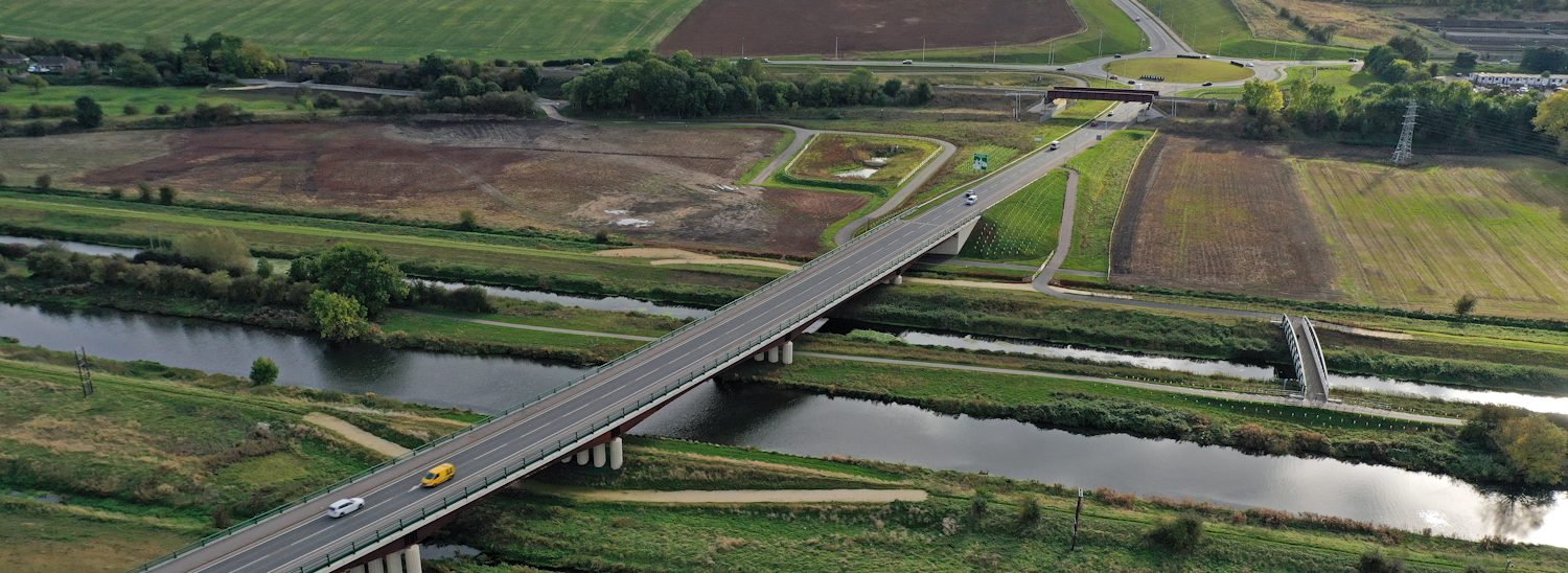 An aerial photograph of part of the Lincoln Eastern Bypass showing a bypass bridge crossing over a river