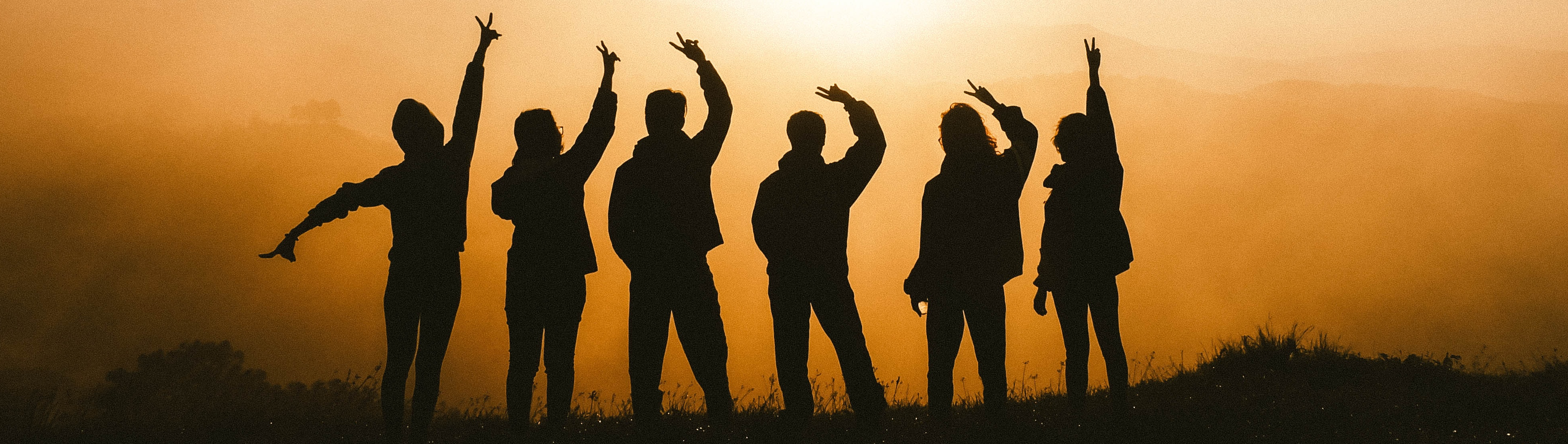 Shadows of young people looking into the sun