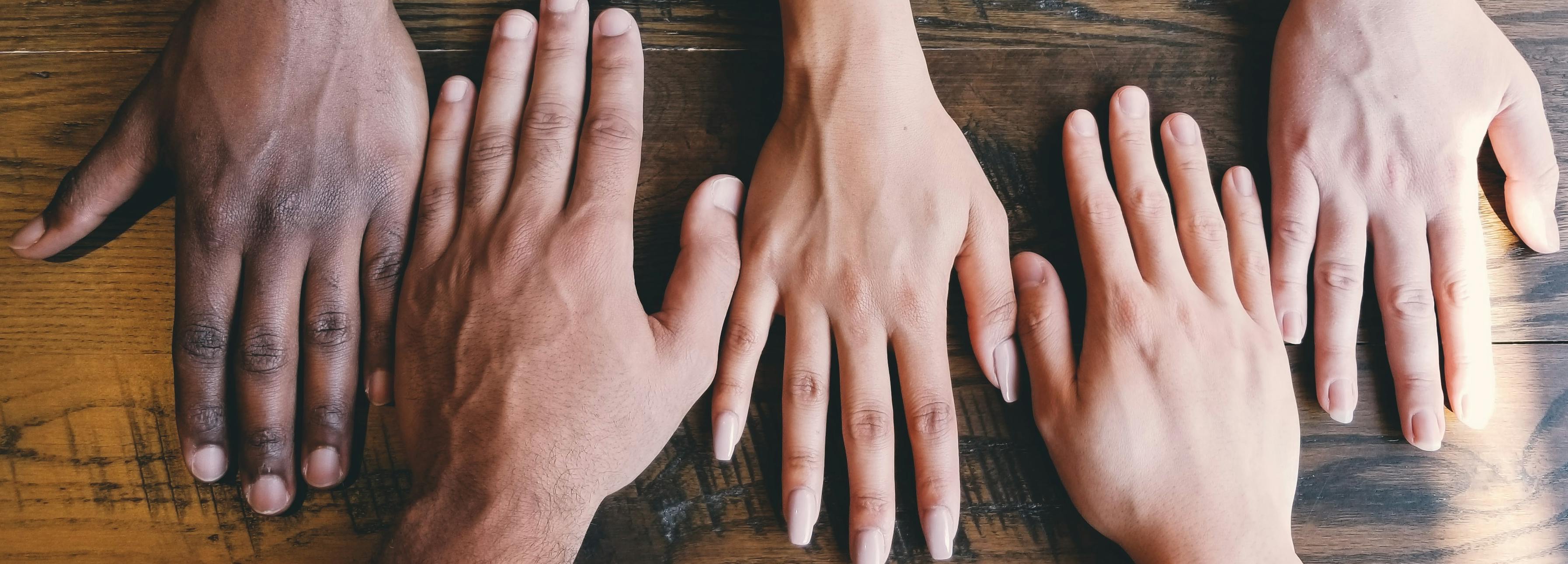 Hands on a table facing each other