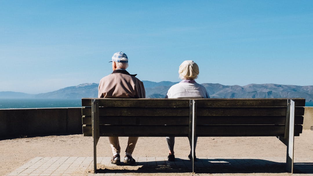 People on bench at the coast