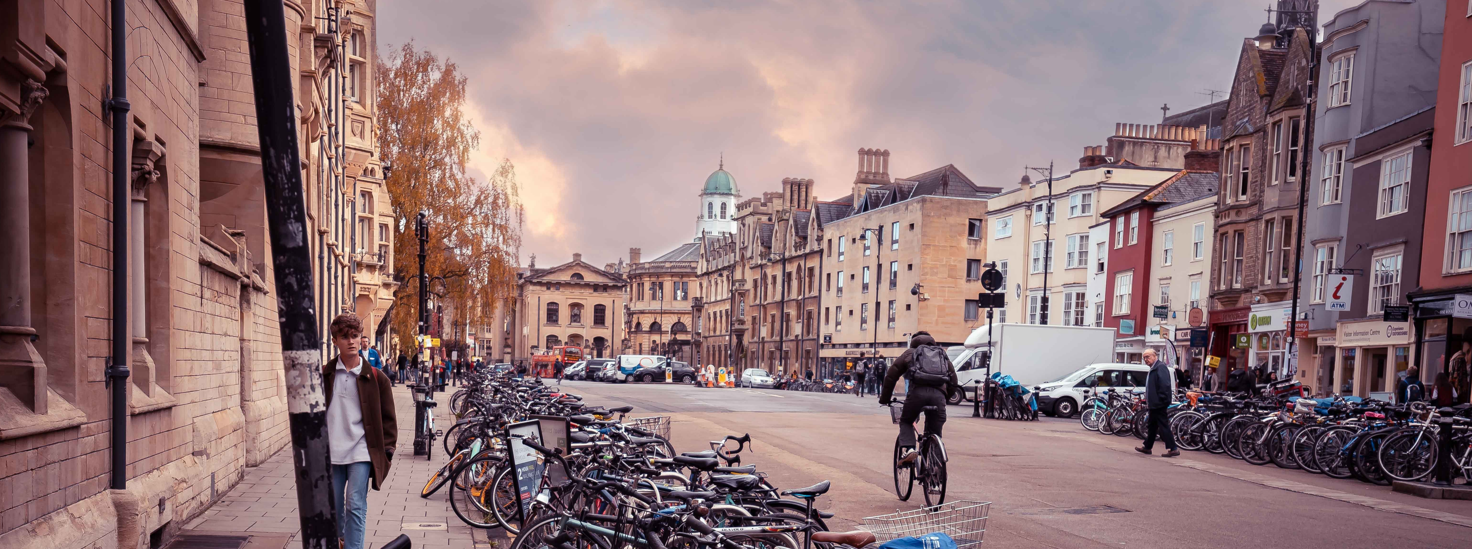 Oxford road with pedestrians, bicycles, cars and a bus