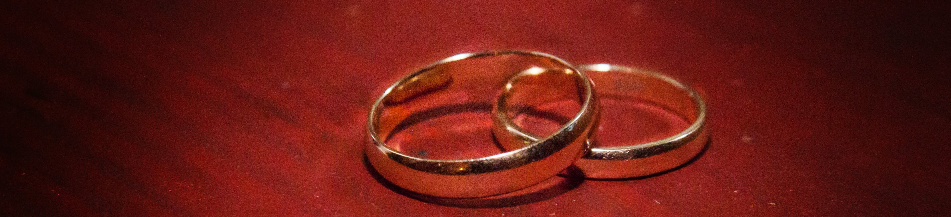 Wedding rings on red paper