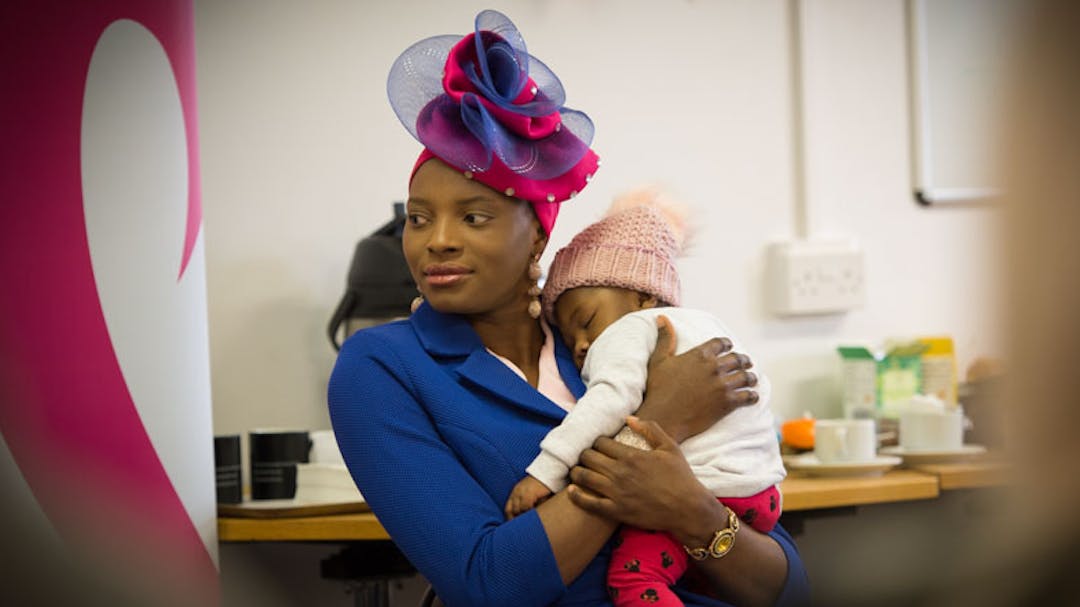 Mum stood holding baby in arms