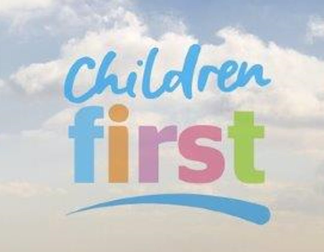 Children first logo, words children and first against a cloudy sky background