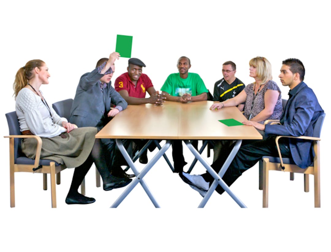 People with learning disabilities having a meeting at a table